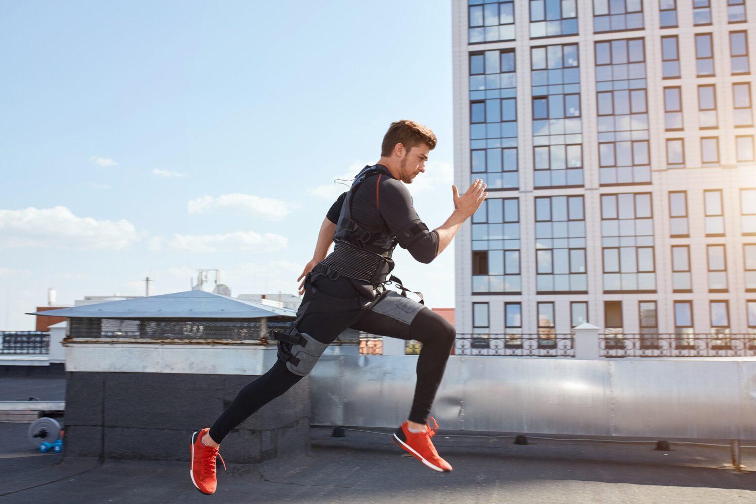 young man in a suit for EMS of a training is jumping