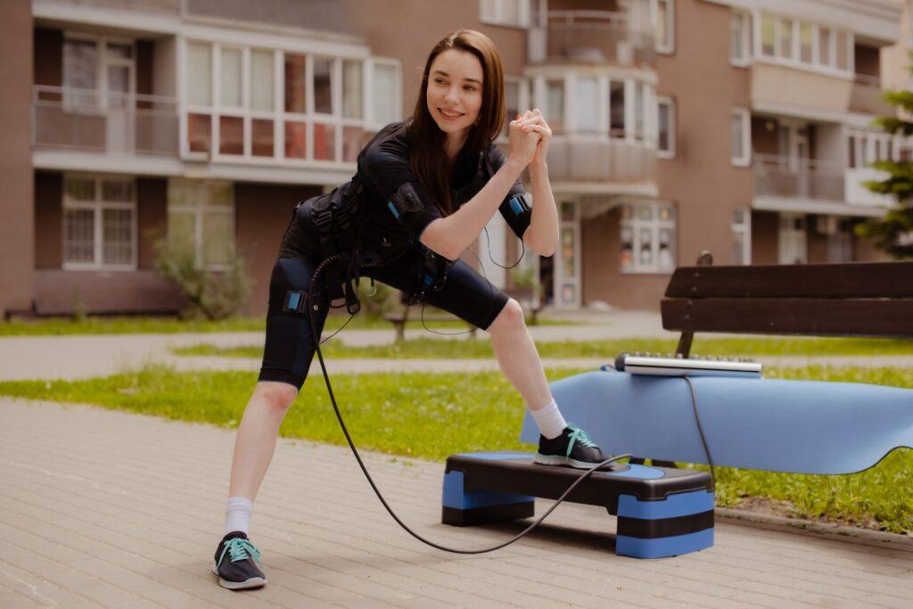 Outdoor EMS Workout: young Woman Embracing Fitness Innovation